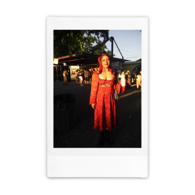 woman wearing a red outfit standing in front of sunlight